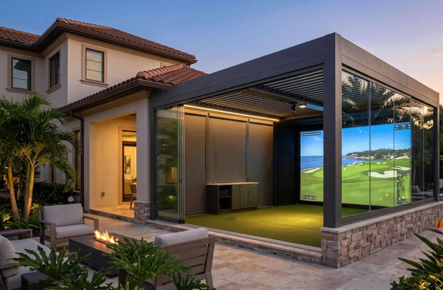 Luxury outdoor golf simulator built inside a modern black pergola enclosure with glass sliding doors, featuring an illuminated hitting bay and a backyard fire pit patio in Seminole, FL.