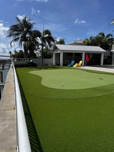 backyard-putting-green-319 1st Street West St Petersburg FL - Sims & Greens Professional backyard putting green in St. Petersburg, FL, featuring custom-engineered undulations, true-roll synthetic turf, and a precision-cut chipping fringe by Sims & Greens.