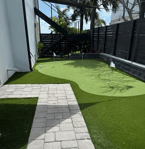 Sims & Greens | Coastal Performance Putting Green | St. Pete Beach, FL - Sims & Greens Professional outdoor putting green in St. Pete Beach, FL by Sims & Greens, featuring a multi-layered aggregate drainage sub-base, true-roll multi-directional turf, and a deep-cut chipping fringe.