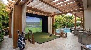 luxury-outdoor-golf-simulator-gazebo-with-wet-bar-clearwater - Sims & Greens A premium outdoor golf simulator gazebo in Clearwater, Florida, featuring a weather-proof enclosure, integrated luxury wet bar with seating, wall-mounted television, and a professional-grade impact screen.