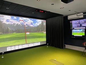 Garage Golf Simulator with AC - Sims & Greens - Sims & Greens Luxury garage golf simulator with mini-split AC installation and SkyTrak launch monitor in Clearwater, FL.