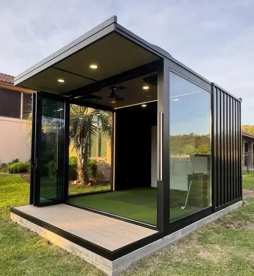 freestanding-outdoor-golf-simulator-gazebo-tampa-fl - Sims & Greens A custom-built, freestanding luxury outdoor golf simulator gazebo installed in a residential backyard in Tampa, Florida, featuring a weather-proof architectural structure, a premium impact screen, and a dedicated hitting area separate from the main house.